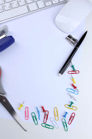 Office table with stationery accessories, keyboard and paper, close upの写真素材