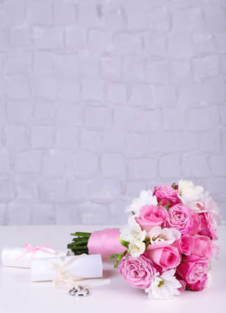 Beautiful wedding still life with bouquet on grey wall backgroundの写真素材