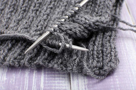 Knitting with spokes on wooden backgroundの写真素材