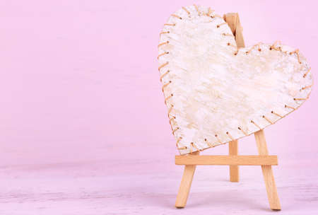 Beautiful heart  small decorative easel on pink backgroundの写真素材
