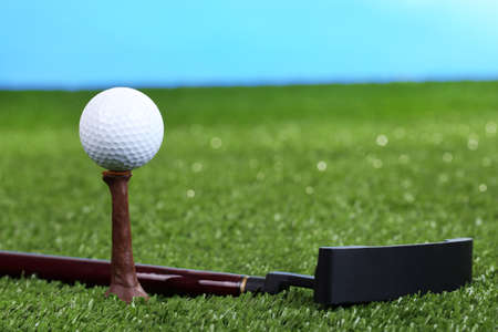 Golf ball and driver on green grass outdoor close upの写真素材