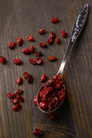 Spice barberry in spoon on wooden の写真素材