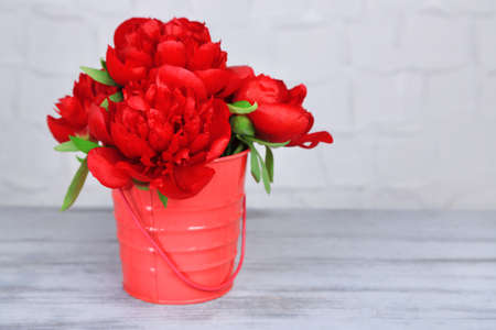 Beautiful pink peonies on grey wall の写真素材