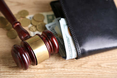 Gavel and money coins on wooden backgroundの写真素材