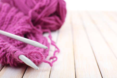 Knitting with spokes on wooden backgroundの写真素材