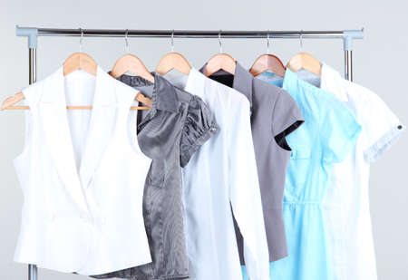 Office female clothes on hangers, on gray backgroundの写真素材