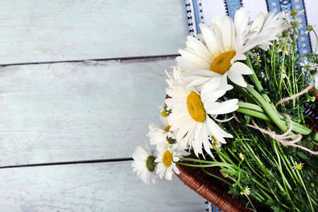 Beautiful bouquet of daisies on wooden backgroundの写真素材