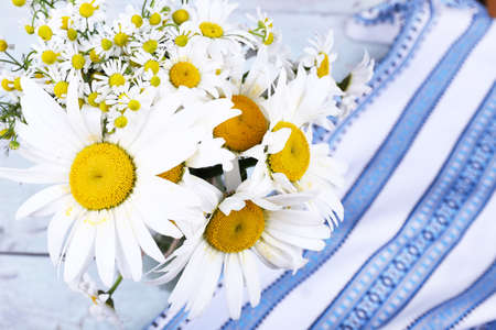 Beautiful bouquet of daisies on wooden backgroundの写真素材