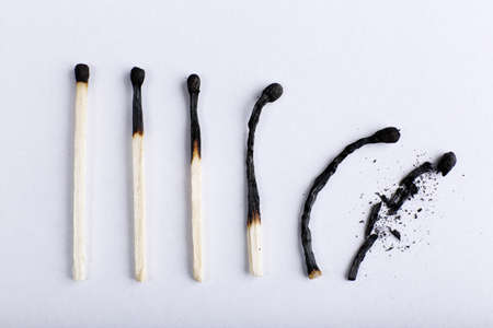  matches in different stages of burning, on color backgroundの写真素材
