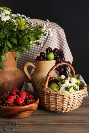 Still life with flowers and fruits on dark backgroundの写真素材