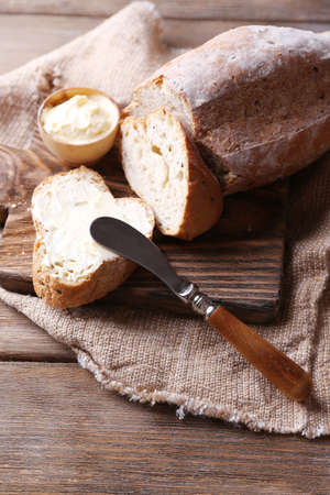 Fresh bread and homemade butter on wooden backgroundの写真素材