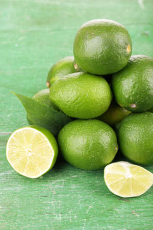 Fresh juicy limes on old wooden tableの写真素材
