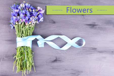 Beautiful bouquet with ribbon on wooden backgroundの写真素材