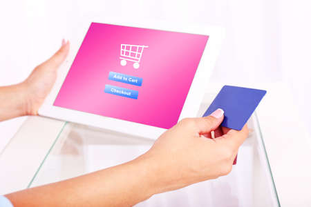 Concept for Internet shopping: hands holding tablet and credit cardの写真素材