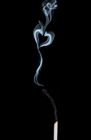 Abstract smoke in shape of heart on black  backgroundの写真素材