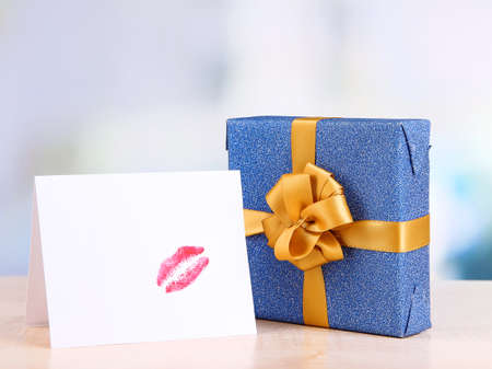Gift with card for loved one on table on room backgroundの写真素材