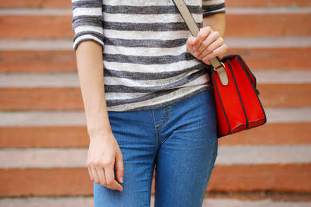 Girl with bag over his shoulder outdoorsの写真素材