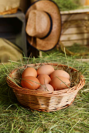 Eggs in wicker basket on table close-upの写真素材