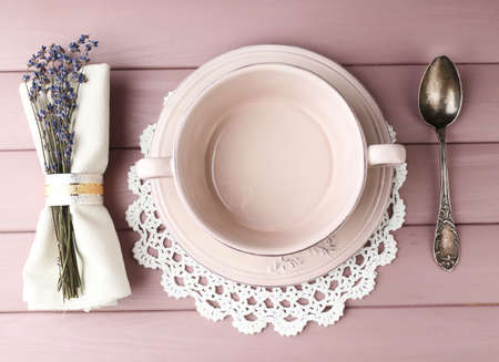 Dining table setting with lavender flowers on wooden table backgroundの写真素材