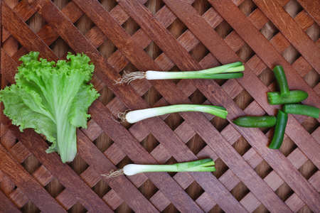 Different slices of vegetables on wooden tableの写真素材