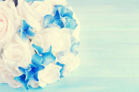 Beautiful wedding bouquet with roses on blue wooden tableの写真素材