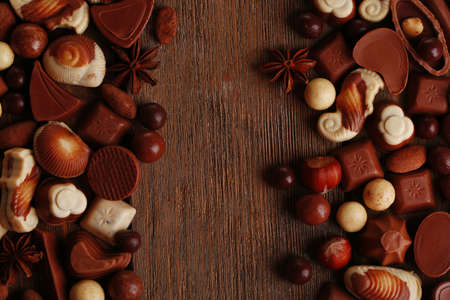 Different kinds of chocolates on wooden table close-upの写真素材