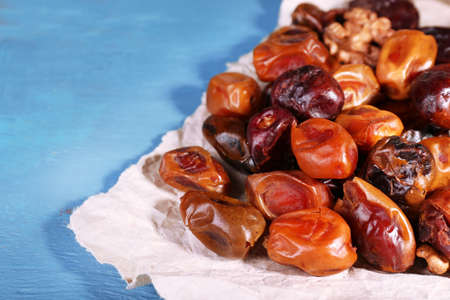 Tasty dates fruits on blue wooden tableの写真素材