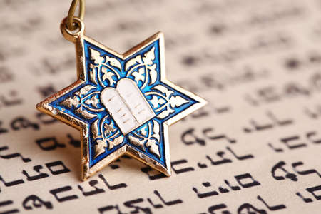 Star David pendant on old paper page backgroundの写真素材