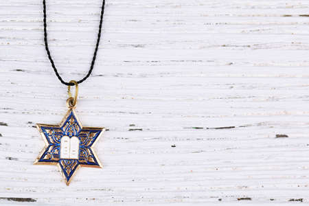 Star David pendant on wooden backgroundの写真素材