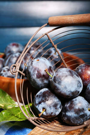 Still life with ripe sweet plums on wooden tableの写真素材