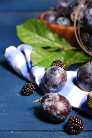 Still life with ripe sweet plums on wooden tableの写真素材