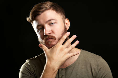 Portrait of handsome man with beard on black backgroundの写真素材