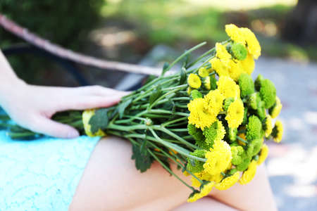 Beautiful bouquet of chrysanthemums flowers on wooden bench in parkの写真素材