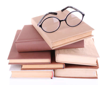 Books in a mess and glasses isolated on whiteの写真素材