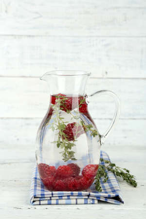 Tasty cool beverage with raspberries and thyme, on light backgroundの写真素材