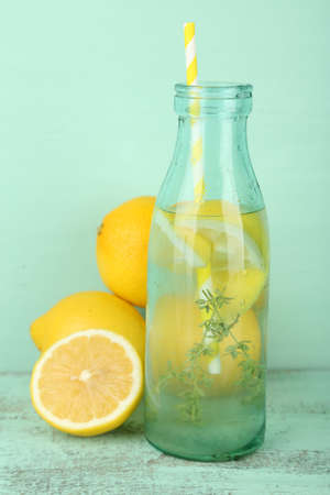 Tasty cool beverage with lemon and thyme, on wooden backgroundの写真素材