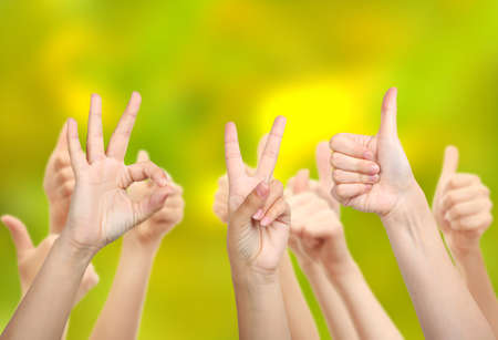 Young people's hands on bright backgroundの写真素材