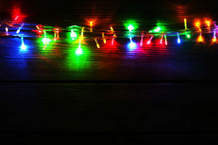 Christmas lights on wooden backgroundの写真素材