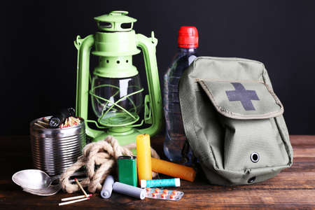 Emergency preparation equipment on wooden table, on dark backgroundの写真素材