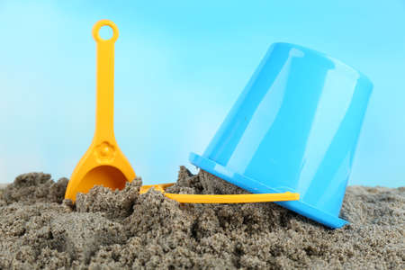 Spade and bucket  on sandy beach backgroundの写真素材