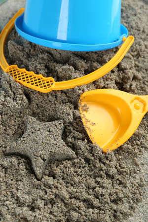 Spade and bucket  on sandy beach backgroundの写真素材