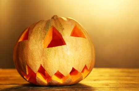 Halloween Pumpkin on wooden table, on color backgroundの写真素材