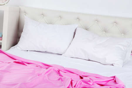 Crumpled pink linen on bedの写真素材