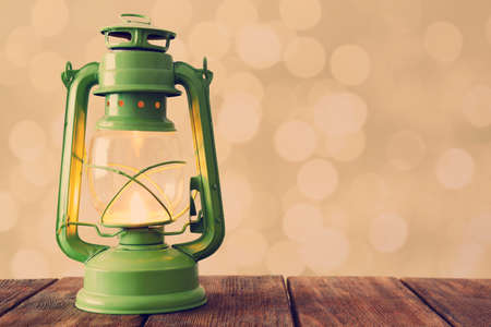 Lantern on wooden table on bright の写真素材