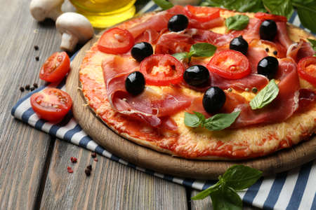 Delicious pizza served on wooden tableの写真素材