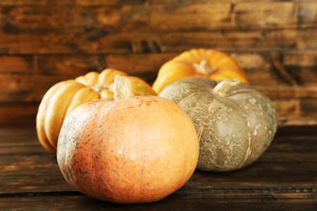 Ripe different pumpkins on wooden backgroundの写真素材