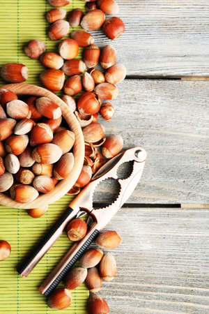 Hazelnuts in wooden bowl on wooden backgroundの写真素材