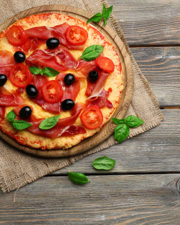 Delicious pizza served on wooden tableの写真素材