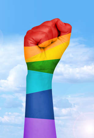 Man's hand painted as the rainbow flag isolated on whiteの写真素材