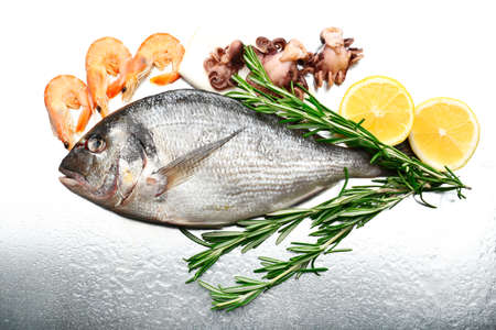 Fresh fish and other seafood with lemon close-upの写真素材